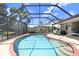 A refreshing pool with screened enclosure, surrounded by lush landscaping and a sunny patio area at 16118 Lytham Dr, Odessa, FL 33556