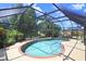 Sparkling pool enclosed by a screen, surrounded by lush landscaping and a spacious deck area at 16118 Lytham Dr, Odessa, FL 33556