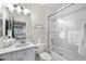 Bright bathroom featuring a glass-enclosed shower and vanity with a large mirror at 16629 Sedona De Avila, Tampa, FL 33613
