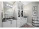 A luxurious bathroom with white cabinets, gray countertops, and a large mirror at 16629 Sedona De Avila, Tampa, FL 33613