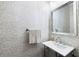 Chic bathroom with patterned wallpaper, a contemporary sink, and a sleek mirror at 16629 Sedona De Avila, Tampa, FL 33613