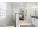 A bathroom featuring a walk-in shower with seamless glass and a view into the primary bedroom at 16629 Sedona De Avila, Tampa, FL 33613