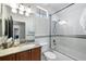 Bathroom featuring a marble countertop and bathtub with glass doors and a shower at 16629 Sedona De Avila, Tampa, FL 33613