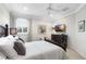 Bedroom with a dark wood frame bed, television, and plenty of natural light at 16629 Sedona De Avila, Tampa, FL 33613