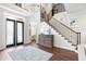 Elegant foyer with wood floors, a staircase, and a decorative light fixture at 16629 Sedona De Avila, Tampa, FL 33613