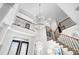 Foyer featuring a staircase, balcony, and contemporary chandelier at 16629 Sedona De Avila, Tampa, FL 33613