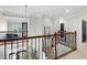 Second story hallway with a wood railing overlooking the living room and a view to the patio at 16629 Sedona De Avila, Tampa, FL 33613