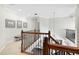 Upstairs landing with wood railing overlooking the first floor and hallway bench seating at 16629 Sedona De Avila, Tampa, FL 33613