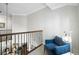 Hallway featuring a chair, tile floors, and decorative iron railing at 16629 Sedona De Avila, Tampa, FL 33613