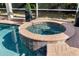 Inviting hot tub with brick surround, complementing the pool and outdoor landscaping at 16629 Sedona De Avila, Tampa, FL 33613