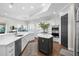 Open kitchen with island, white cabinetry, stainless appliances, and eat-in breakfast bar at 16629 Sedona De Avila, Tampa, FL 33613