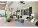 Elegant covered patio with plush seating, ceiling fans, and an outdoor TV for ultimate relaxation by the pool at 16629 Sedona De Avila, Tampa, FL 33613