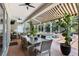 Inviting outdoor patio with a dining table, wicker chairs, and view of the pool and landscaping at 16629 Sedona De Avila, Tampa, FL 33613