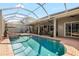 Gorgeous screened pool area with covered lounge, spa, and lush backyard views for luxurious outdoor living at 16629 Sedona De Avila, Tampa, FL 33613