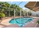 Sparkling pool with spa, lush tropical landscaping, screened enclosure, and brick patio at 16629 Sedona De Avila, Tampa, FL 33613