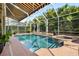 Relaxing screened pool with spa, surrounded by lush landscaping and a brick patio at 16629 Sedona De Avila, Tampa, FL 33613