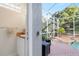 Poolside powder room access; convenience for outdoor gatherings, seamlessly blending indoor comfort with backyard enjoyment at 16629 Sedona De Avila, Tampa, FL 33613