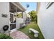 Side yard with well manicured landscaping and pavers leading to screened pool area and lounge at 16629 Sedona De Avila, Tampa, FL 33613