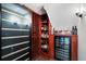 Custom wine cellar featuring a large wine fridge and shelving for ample storage of bottles and beverages at 16629 Sedona De Avila, Tampa, FL 33613
