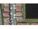 Overhead view of community homes, some featuring pools, situated alongside a peaceful pond at 17583 Holly Well Ave, Wimauma, FL 33598