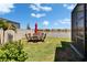 The backyard features a patio table set with a beautiful lake view, perfect for outdoor dining at 17583 Holly Well Ave, Wimauma, FL 33598