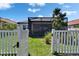 Backyard oasis featuring a screened-in patio and beautiful landscaping, perfect for relaxation at 17583 Holly Well Ave, Wimauma, FL 33598