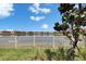 Enjoy the tranquility of the water view from the lush backyard with a decorative Magnolia tree at 17583 Holly Well Ave, Wimauma, FL 33598