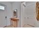Cozy foyer featuring a wooden console table, art, and access to other rooms at 17583 Holly Well Ave, Wimauma, FL 33598