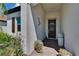 View of the covered front porch with beautiful tile flooring and decor at 17583 Holly Well Ave, Wimauma, FL 33598