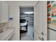 Attached garage with ample storage space, view of a car and wall decoration with a countertop at 17583 Holly Well Ave, Wimauma, FL 33598