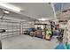 Spacious garage with ample storage, featuring two garage doors, storage shelving and organization at 17583 Holly Well Ave, Wimauma, FL 33598