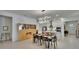 A bright, open concept kitchen and dining area with island seating, stainless steel appliances and modern lighting at 17583 Holly Well Ave, Wimauma, FL 33598
