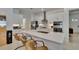 Modern kitchen with white cabinets, stainless steel appliances, and an island with seating at 17583 Holly Well Ave, Wimauma, FL 33598