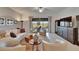 Bright living room with elegant furnishings, neutral colors, and access to the outdoor space at 17583 Holly Well Ave, Wimauma, FL 33598