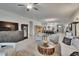 Open-concept living room features neutral decor, stylish furniture, and views into the kitchen at 17583 Holly Well Ave, Wimauma, FL 33598