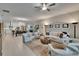Spacious living room showcasing open concept design, neutral decor, and connection to the kitchen at 17583 Holly Well Ave, Wimauma, FL 33598