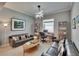 Sitting area with sofas, decor, lighting, shelving and a window that provides natural light at 17583 Holly Well Ave, Wimauma, FL 33598