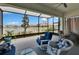 Enjoy the serene lake view from this screened patio with wicker seating, perfect for relaxing outdoors at 17583 Holly Well Ave, Wimauma, FL 33598