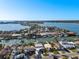 An aerial view of waterfront homes with private docks, and access to the surrounding waterways and bay at 17730 Long Point Dr, Redington Shores, FL 33708