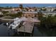 Aerial view of waterfront home with boat dock, tropical landscaping, and canal access at 17730 Long Point Dr, Redington Shores, FL 33708