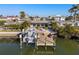 Aerial view of waterfront home with boat dock, tropical landscaping, and canal access at 17730 Long Point Dr, Redington Shores, FL 33708