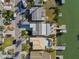 Aerial view of houses showcasing well-maintained landscaping, driveways, and backyard docks at 17730 Long Point Dr, Redington Shores, FL 33708