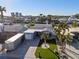 Aerial view of a home with a brick driveway, manicured lawn, and canal access at 17730 Long Point Dr, Redington Shores, FL 33708
