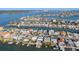 An aerial view of homes along canals, with private docks, and waterfront access to the open bay beyond at 17730 Long Point Dr, Redington Shores, FL 33708