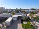 An aerial view of a well-maintained home highlighting its landscaped yard, brick driveway, and waterfront location at 17730 Long Point Dr, Redington Shores, FL 33708