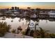 Scenic aerial view of waterfront homes with private docks along a tranquil canal at sunset at 17730 Long Point Dr, Redington Shores, FL 33708