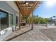 Covered patio with fan overlooks a lush tropical landscape and waterfront at 17730 Long Point Dr, Redington Shores, FL 33708