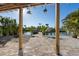 Backyard view through a covered patio of boat dock and waterfront on a sunny day at 17730 Long Point Dr, Redington Shores, FL 33708