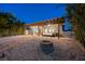 Backyard featuring a covered patio, outdoor furniture, grill, lush tropical landscaping, and fire pit at 17730 Long Point Dr, Redington Shores, FL 33708
