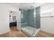 Bathroom featuring a glass shower with geometric tile and a built in bench near the main bedroom at 17730 Long Point Dr, Redington Shores, FL 33708